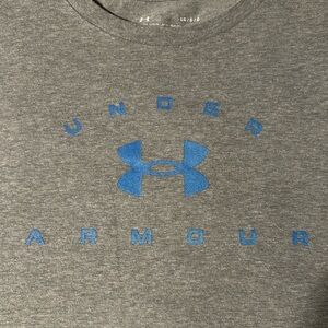 Grey under armour shirt with blue on the front. Size large, also says loose